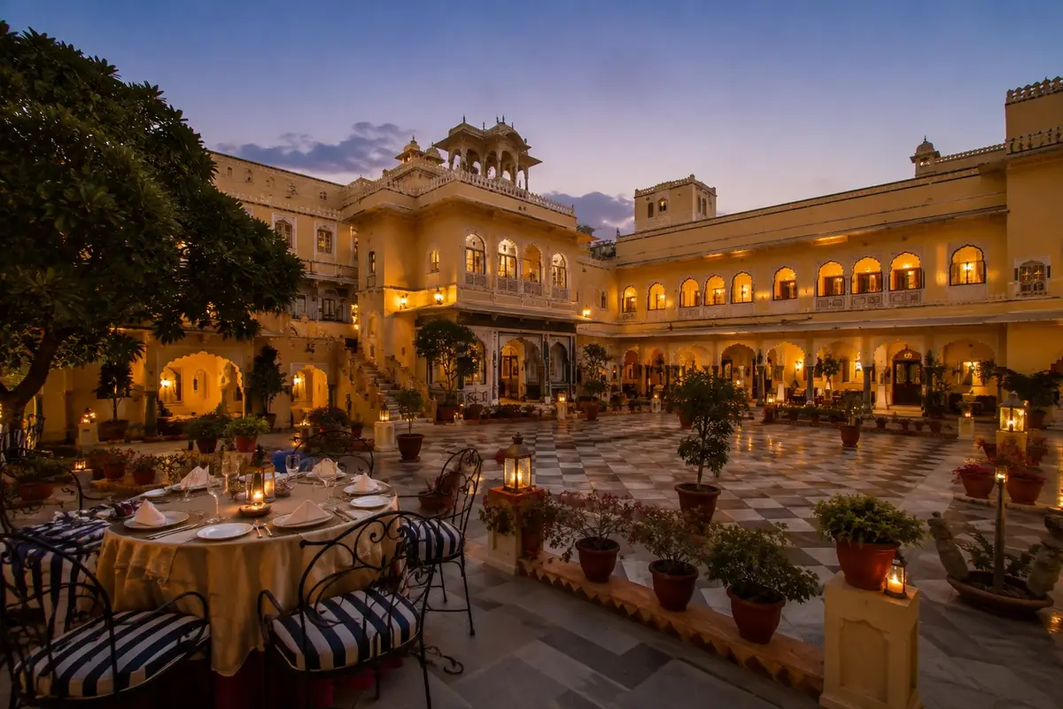 Luxurious heritage palace hotel in Rajasthan featuring grand courtyards, royal architecture, and elegant evening ambiance.