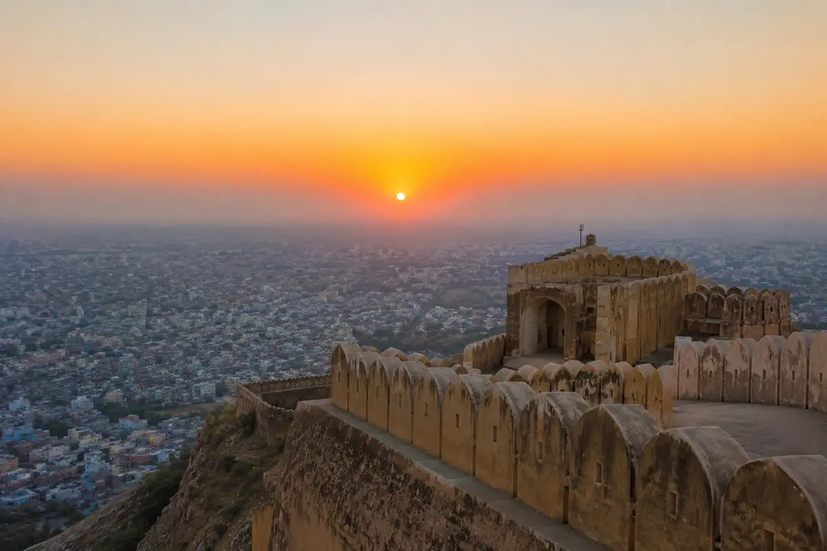 Sunrise view from Nahargarh Fort overlooking Jaipur city with historic fort walls glowing in the morning light.